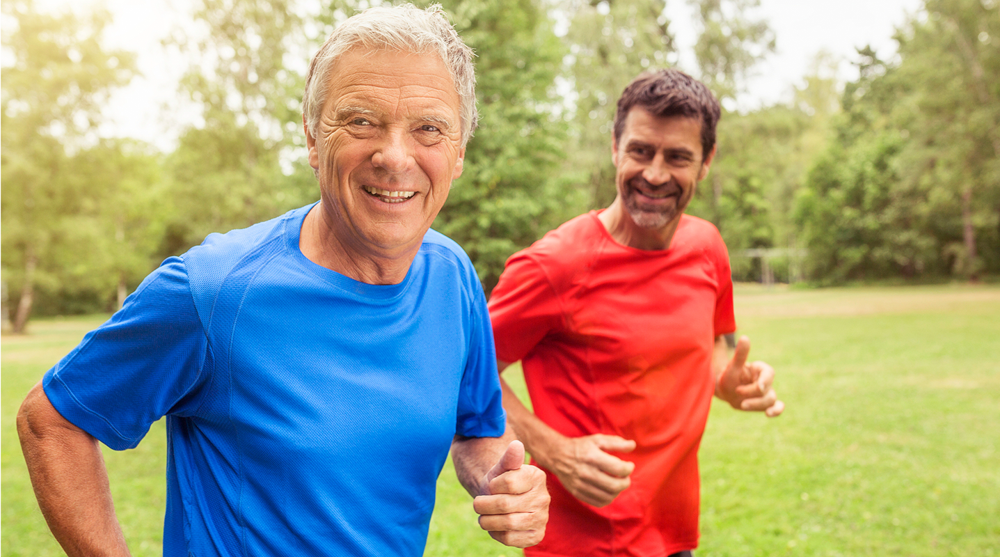 two men jogging in park