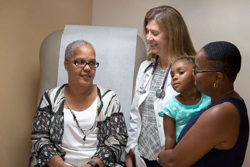 Patient Dolores with visitor family and medical staff